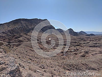 Road running through vast desert landscape Stock Photo