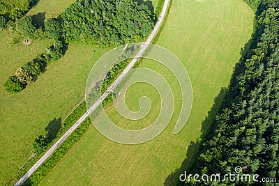 A road runs through green countryside in Europe, France, Burgundy, Nievre, towards Chateau Chinon, in summer on a sunny day Stock Photo