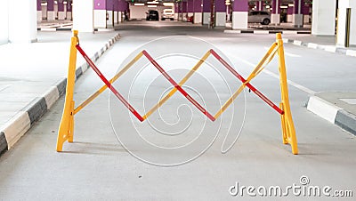 Road Safety Block Traffic Metal Portable Retractable Barricade at a parking spot Stock Photo