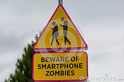 Road sign - beware of smartphone zombies Stock Photo