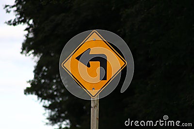 Road sign indicating sharp left turn ahead Stock Photo