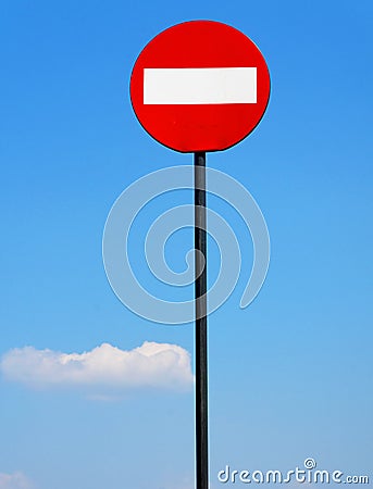 Road sign on a metal pole `Do not enter` sign against a blue sky with white clouds background. Stock Photo