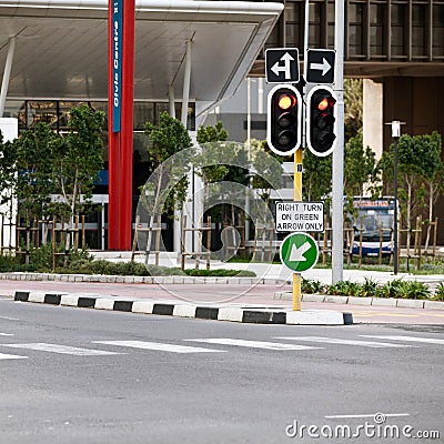 Road sign, traffic light and city with arrow for direction with travel information, typo or mistake for humor. Street Stock Photo