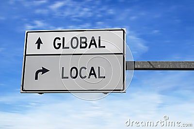 Road sign with words global and local. White two street signs with arrow on metal pole on blue sky background Stock Photo