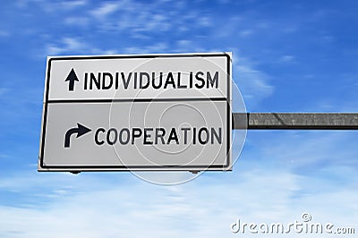 Road sign with words individualism and cooperation. White two street signs with arrow on metal pole. Directional road, Crossroads Stock Photo