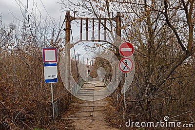 Road signs restrict and prohibit entry and entry to the emergency bridge, across the river. Stock Photo