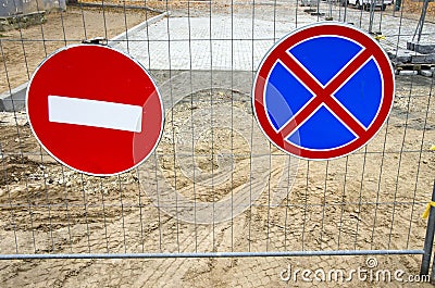 Road signs on street repair fence Stock Photo