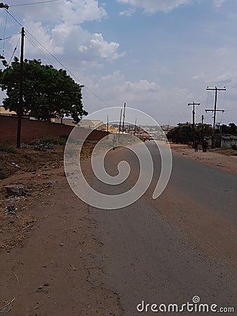 Road small houses poles trees Stock Photo