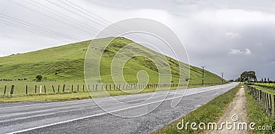 Road 50 and smooth hills in a green rustic landscape, near Ongaonga, New Zealand Stock Photo