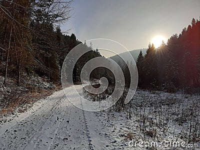 Road snow sun watching three shadow moutains Stock Photo