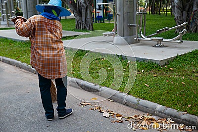 Road sweeper worker cleaning city street Editorial Stock Photo