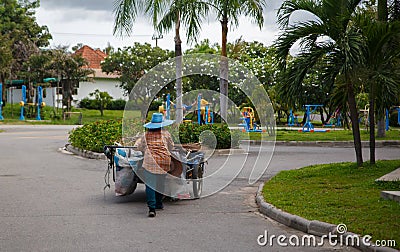 Road sweeper worker cleaning city street Editorial Stock Photo