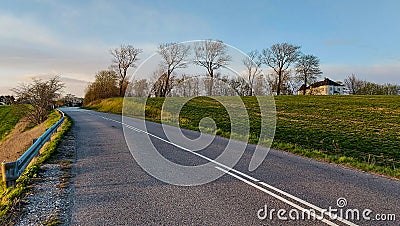 Road throught Danish agricultural field Stock Photo