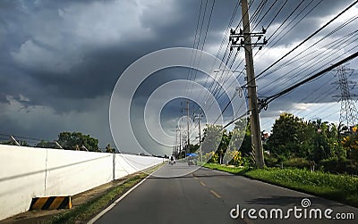 Road to Rain. Half zone raining and sunny. Rain cloud ahead on road. Rain is not all over the sky Stock Photo