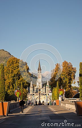 Road to Sanctuary of Our Lady in Lourdes, France. Famous religious centre of pilgrims. Aerial view of catholic cathedral. Stock Photo