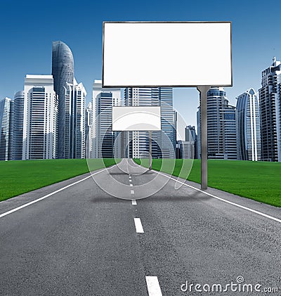Road into town with established billboards. Stock Photo