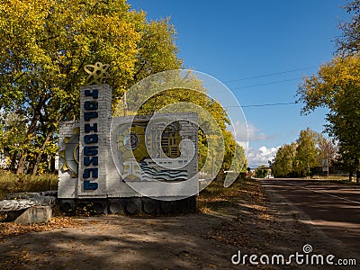 Road and town sign at the entrance of the abandoned city of Chernobyl in the Ukraine Editorial Stock Photo