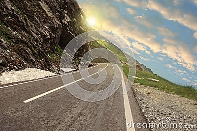 Road trip. View of asphalt highway along crag on sunny day Stock Photo