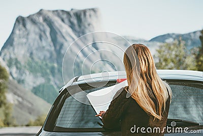 Road trip Woman car driver with map planning journey route in Norway Travel Lifestyle concept adventure vacations outdoor rocky mo Stock Photo