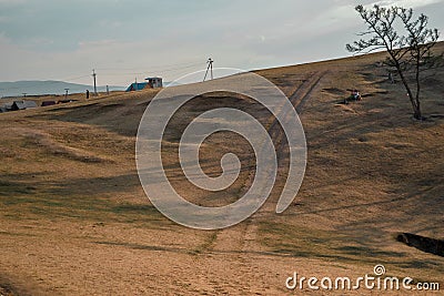 road uphill in the steppe area on istand Olkhon near rustic village of Khuzhir, Baikal Stock Photo