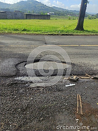 the road is very dangerous and potholes Stock Photo