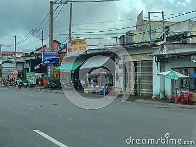 Road view with buildings and shops on roadside in city Ho Chi Minh in Vietnam Editorial Stock Photo