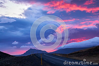 Road in Western Iceland at sunset time with dramatic sky Stock Photo