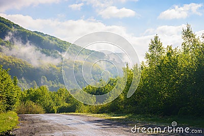 road winds through the foggy countryside Stock Photo
