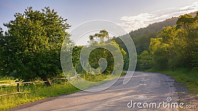 road winds through the lush green countryside Stock Photo