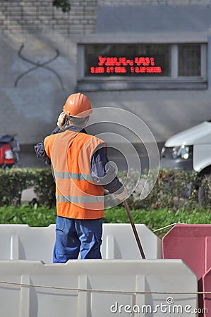 Road worker talking on the phone Editorial Stock Photo