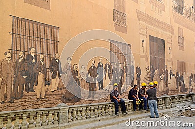 Road workers near the historical painted wall in Havana Editorial Stock Photo