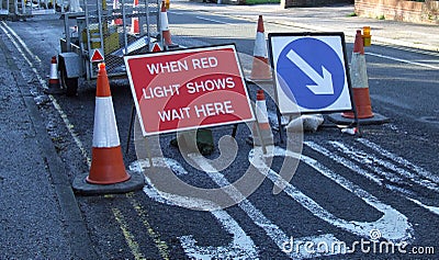 Road works with when red light shows wait here sig Stock Photo
