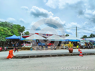 A roadside stall and a complex Padang Waremart near at the Thailand border in Perlis, Malaysia. Editorial Stock Photo