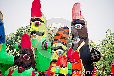 roadside streetside shot of huge paper mache effigies puppets of demon ravana being built in colorful paper to be burnt Editorial Stock Photo