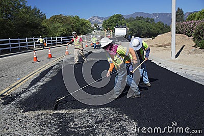 Roadworkers repaves road with steam, Encino Drive, Oak View, California, USA Editorial Stock Photo