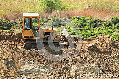 Roadworks, yellow bulldozer work Editorial Stock Photo