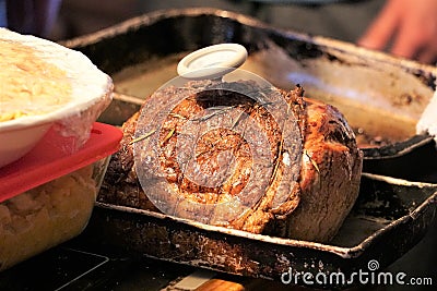 Roast beef with meat thermometer next to prepped mashed potatoes Stock Photo