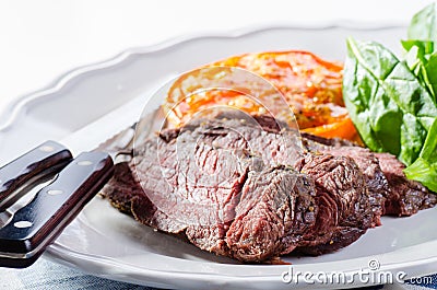 Roast beef with salad, roasted tomato and pepper sauce Stock Photo