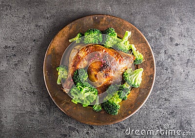 Roast chicken Leg. Chicken roasted leg with broccoli on concrete Stock Photo