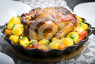 Roast chicken with potatoes Stock Photo