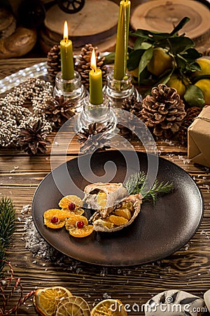 Roast Christmas duck with orange on wooden table on decorated christmas background Stock Photo