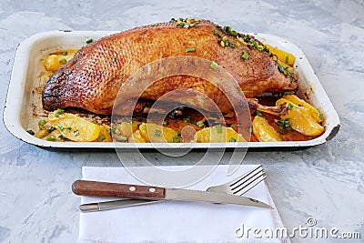 Roasted duck sauce with oranges on a gray background. Stock Photo