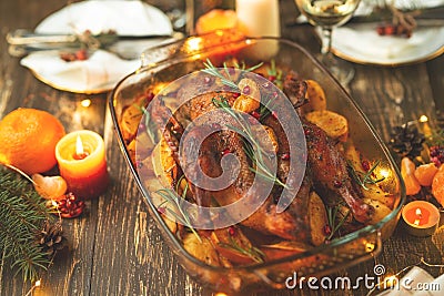 Roast duck. Thanksgiving table served with turkey, decorated with rosemary and pomegranate seeds and candles. Roast duck, table. Stock Photo