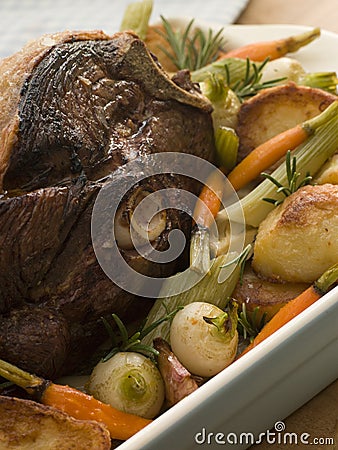 Roast Leg of Spring Lamb With Roast Potatoes Stock Photo