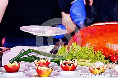 Roast pig. Roasted piglet with vegetables on platter Stock Photo