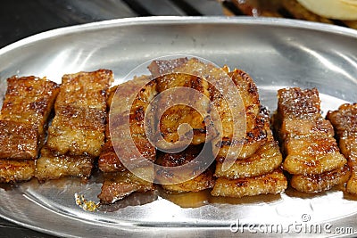 Roast Pork topped with apple sauce on the stainless steel plate. Stock Photo