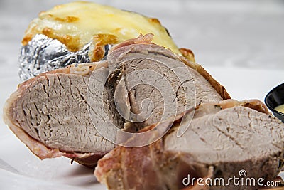 Roast pork, wrapped in bacon Stock Photo