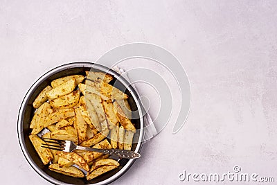 Roasted or Baked Potatoes With Spice in Black Bowl on Light Gray Background Tasty Homemade Dish Dinner Grilled Potatoes Copy Space Stock Photo