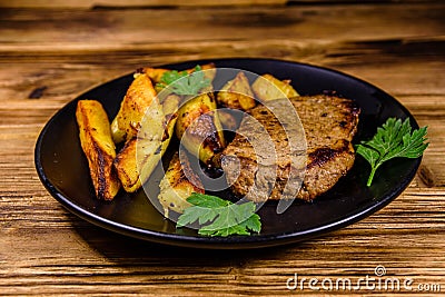 Roasted beefsteak with the fried potato and parsley Stock Photo