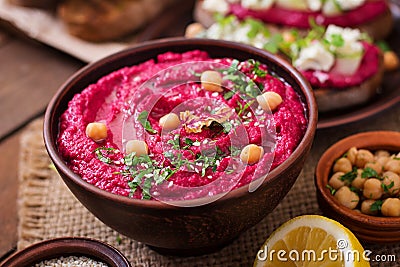 Roasted Beet Hummus with toast in a ceramic bowl Stock Photo